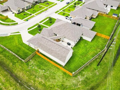 Aerial view of the large corner private lot and oversized detached garage/carport.