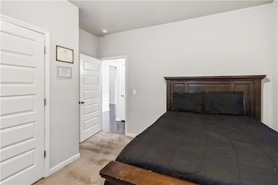 Bedroom featuring baseboards and light colored car
