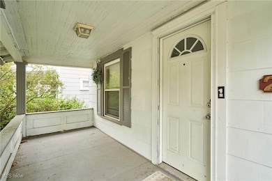 View of exterior entry featuring a porch