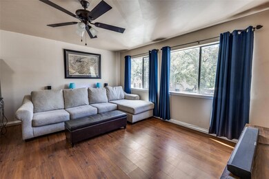Living area with baseboards, ceiling fan, and wood finished floors