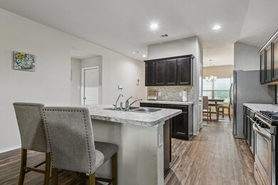 The space connects to a dining area with natural l