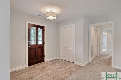 Entry Foyer features two coat closets that mirror 
