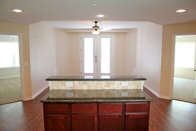 Kitchen featuring ceiling fan, dark hardwood / woo