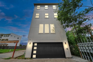 Modern, four-story home with sleek exterior, large