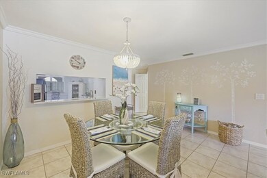 Dining space featuring a chandelier, crown molding