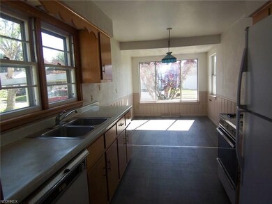 A view of the kitchen and dining room from laundry