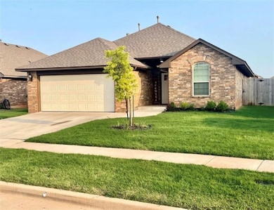 Ranch-style house featuring a garage and a front yard