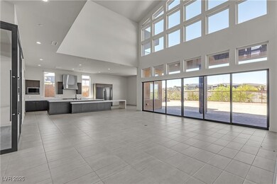 Unfurnished living room with a towering ceiling, l