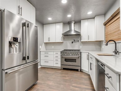 Kitchen featuring dark wood-style flooring, a sink
