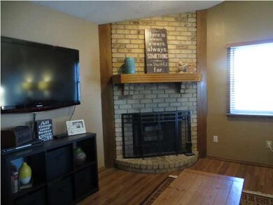 Cozy wood burning fireplace highlights the living 
