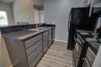 Kitchen with a sink, black appliances, a peninsul