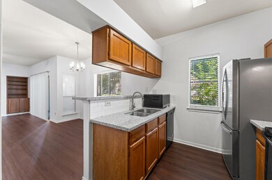 The kitchen opens seamlessly to the dining area, c