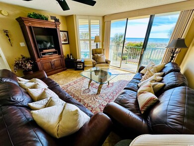 Living room featuring ceiling fan, a textured ceil