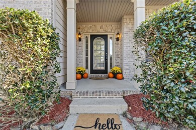 Property entrance featuring brick siding and a porch
