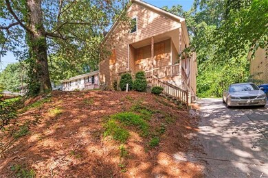 View of front of property featuring a porch, stairway, and driveway