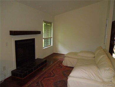Living room with wood floors and fireplace.