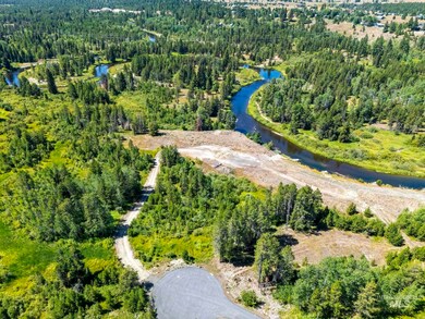 Drone / aerial view of a large body of water and a heavily wooded area