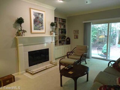 Den/Family/Great Room. Doors lead to private patio overlooking wooded area