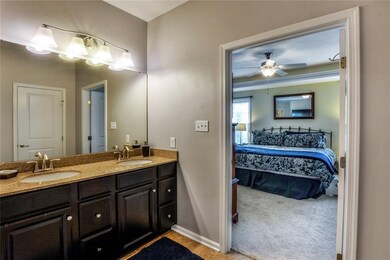 Double vanity in the master bath has a granite cou