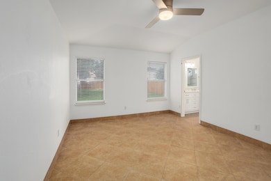 Unfurnished room featuring ceiling fan, vaulted c