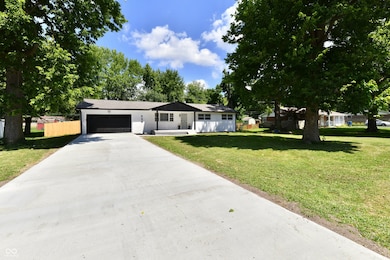 single story home with an attached garage and concrete driveway