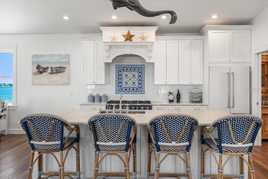 Fantastic Light Granite Island , Chairs you know the name :), La Cornue Range, yes, it it true! This converys, oh and porcelain imported fancy tile backsplash