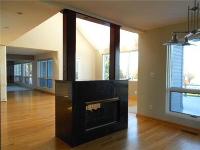 Living Room. A view of the fireplace from the dini