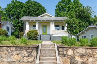 Home is elevated above street level with nice stone retaining wall and entry steps