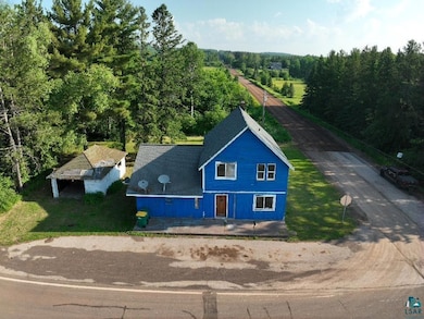 View from above of property featuring a heavily wooded area