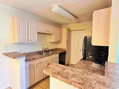Kitchen featuring a sink, a peninsula, black appli