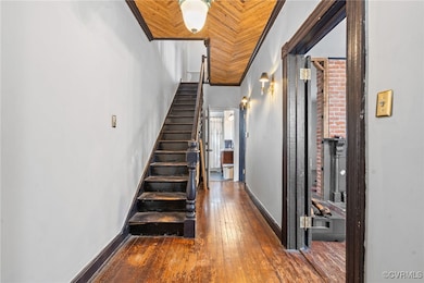 Stairs featuring crown molding, a high ceiling, an