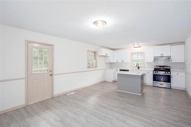 Kitchen with stainless steel gas range, under cabi