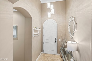 Entrance foyer with baseboards and arched walkways