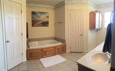 Master bathroom features separate shower and tub, his/her walk-in closets, dual vanities and is handicapped accessible. 