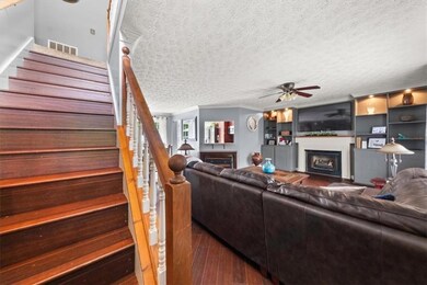 Living area with a fireplace, wood finished floors