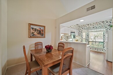 The bright kitchen opens up to the formal dining r