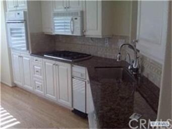 The kitchen has beautiful granite countertops and 