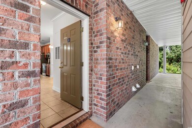 Doorway to property featuring a porch