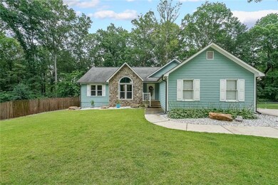 Ranch-style house with stone siding and roof with shingles
