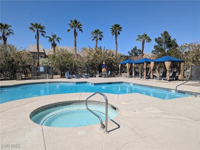 Community pool with a hot tub and a patio area