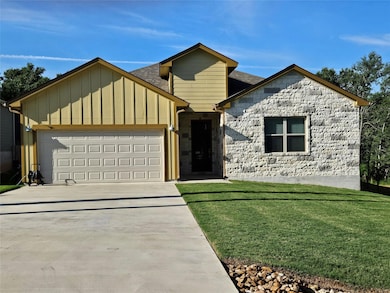 View of front facade with roof with shingles, an 