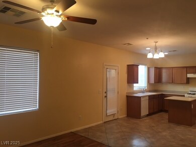 Kitchen featuring a sink, a ceiling fan, white app