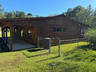 View of side of home with a yard