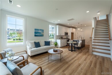 Hardwood floored living room with ornamental moldi