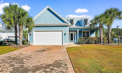 View of front of property with a front yard, a gar