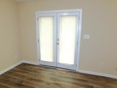 Doorway to outside featuring dark wood-type floori