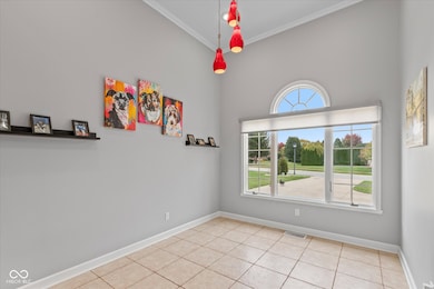 Office featuring light tile floors and crown molding