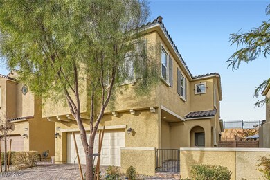 View of property with decorative driveway, a fence