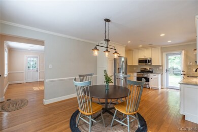 Dining area open to the kitchen, which has a door to the back yard & patio. To the left you see the living room with the door to the screened porch.