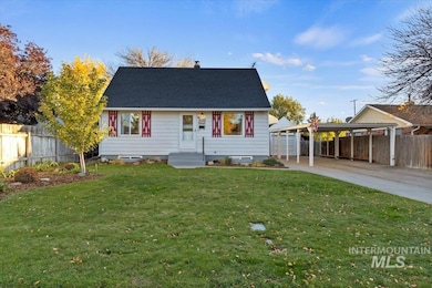 View of front facade featuring a chimney, roof with shingles, driveway, and a carport